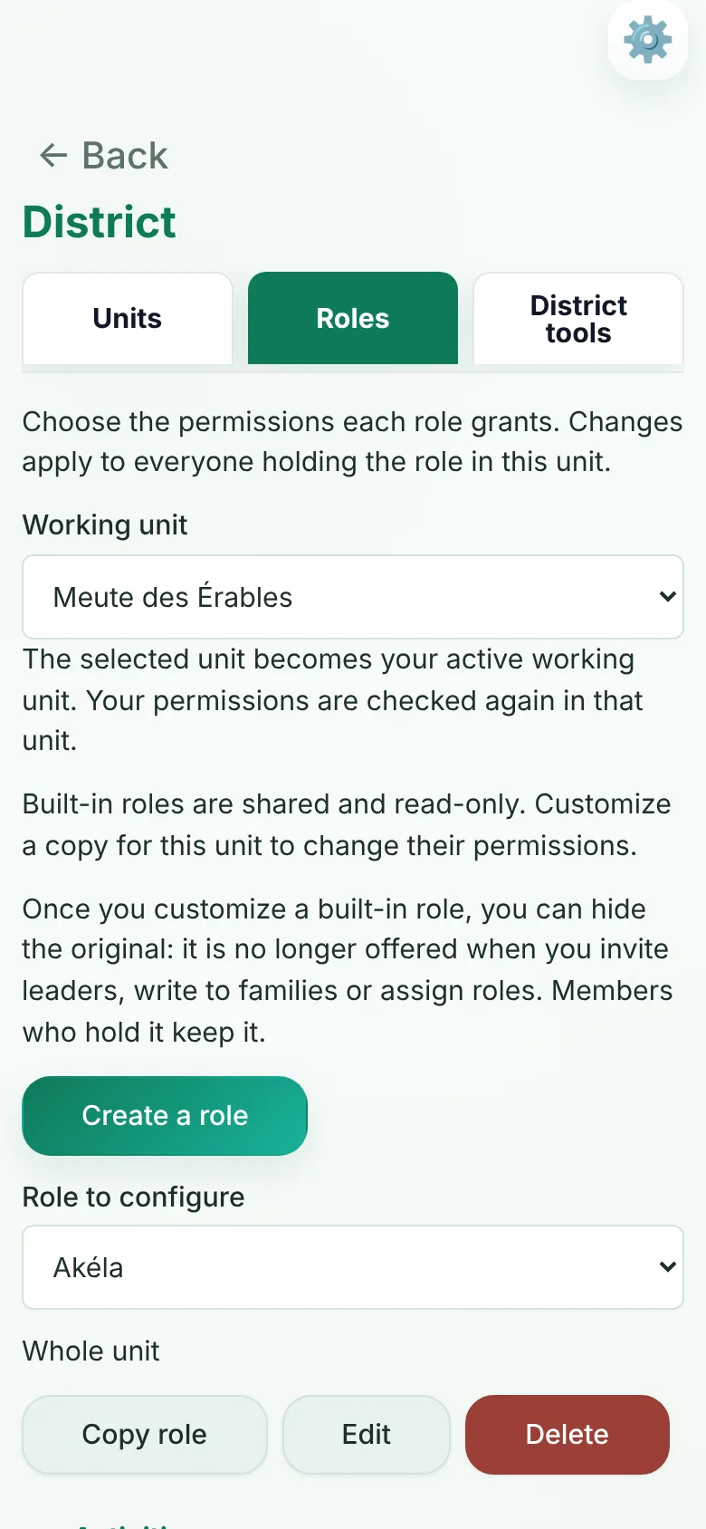District Roles tab on a phone: choose the working unit, then the permissions each role grants; built-in roles can be customized for the unit, and the original hidden.